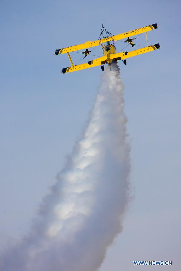 Catwalk or Skycats of the Scandinavian Aerobatic Team leave a trail of Indian tri-colour smoke as they perform aerobatics on the second day of the Aero India 2015 in Air Force Station Yelahanka of Bengaluru, Karnataka of India, Feb. 19, 2015. The biennial air show this year attracted dealers from 49 countries such as US, Russia, France, Israel, UK and so on.