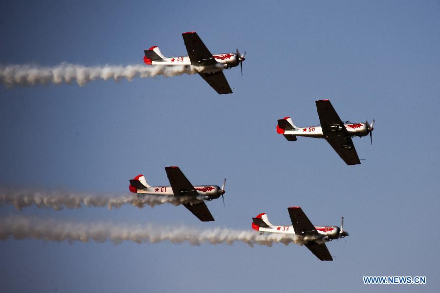 A four aircraft aerobatic display team from the UK flying Russian-origin Yak aircrafts perform during the Aero India 2015 in Air Force Station Yelahanka of Bengaluru, Karnataka of India, Feb. 19, 2015, the second day of the event. The biennial air show this year attracted dealers from 49 countries such as US, Russia, France, Israel, UK and so on. 