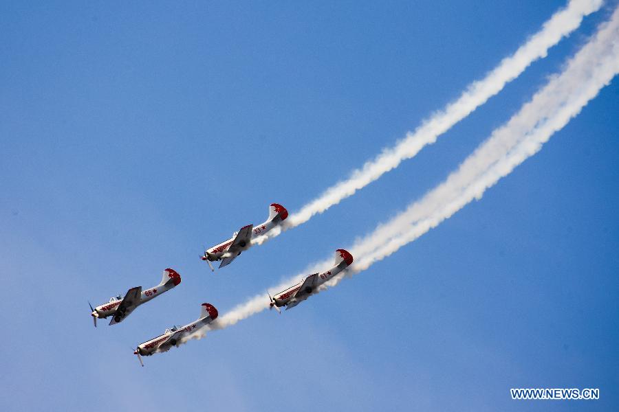 Catwalk or Skycats of the Scandinavian Aerobatic Team leave a trail of Indian tri-colour smoke as they perform aerobatics on the second day of the Aero India 2015 in Air Force Station Yelahanka of Bengaluru, Karnataka of India, Feb. 19, 2015. The biennial air show this year attracted dealers from 49 countries such as US, Russia, France, Israel, UK and so on.