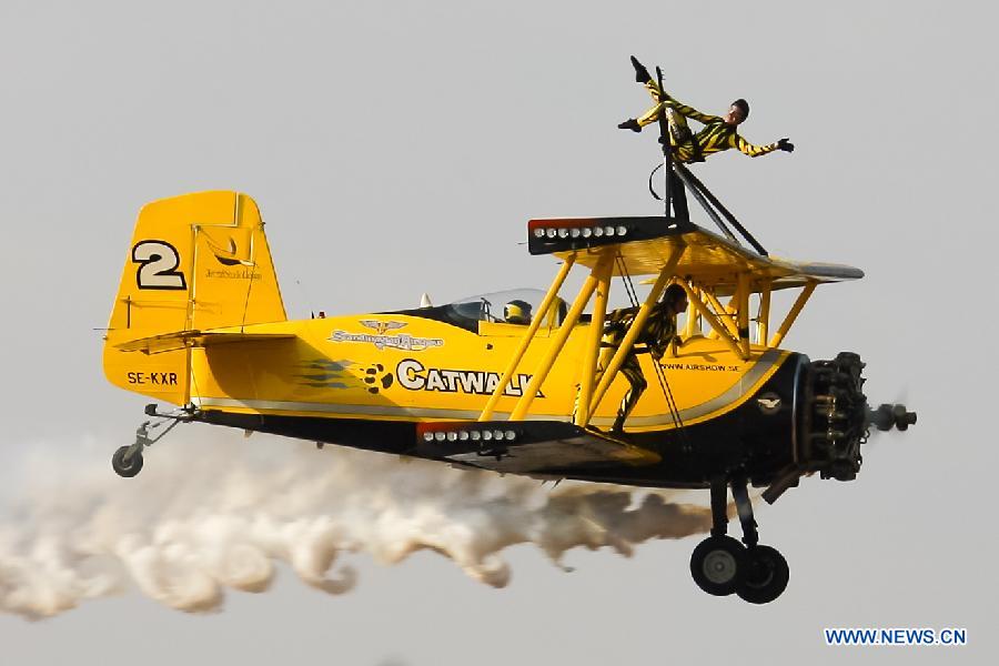 Catwalk or Skycats of the Scandinavian Aerobatic Team leave a trail of Indian tri-colour smoke as they perform aerobatics on the second day of the Aero India 2015 in Air Force Station Yelahanka of Bengaluru, Karnataka of India, Feb. 19, 2015. The biennial air show this year attracted dealers from 49 countries such as US, Russia, France, Israel, UK and so on.