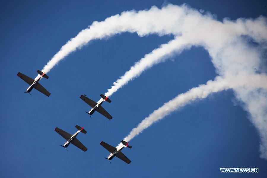 Catwalk or Skycats of the Scandinavian Aerobatic Team leave a trail of Indian tri-colour smoke as they perform aerobatics on the second day of the Aero India 2015 in Air Force Station Yelahanka of Bengaluru, Karnataka of India, Feb. 19, 2015. The biennial air show this year attracted dealers from 49 countries such as US, Russia, France, Israel, UK and so on.