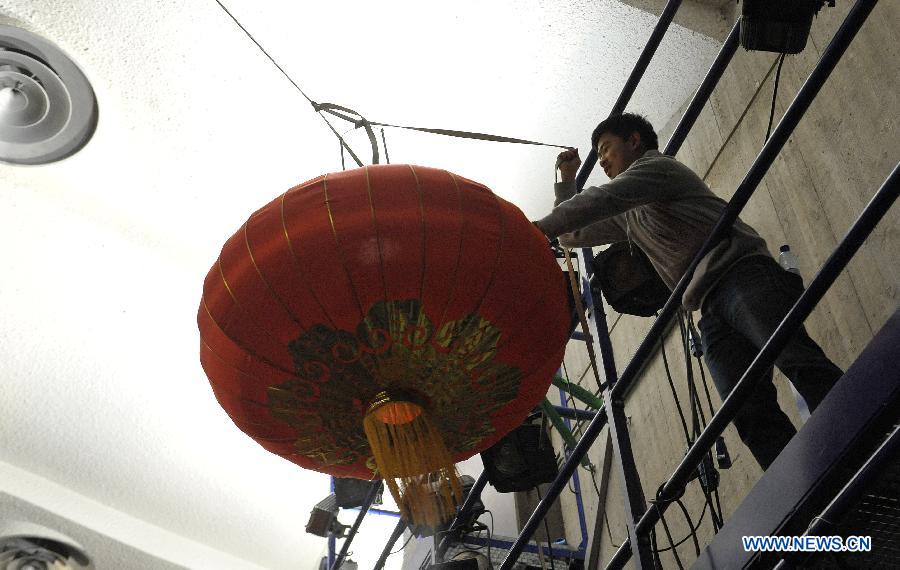 A Chinese student helps with the decoration after the Chinese Spring Festival soiree, organized by Chinese students in Brussels, Belgium, Feb. 25, 2015.