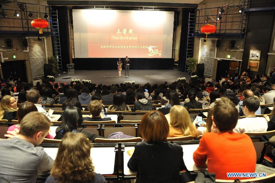 People watch the Chinese Spring Festival soiree, organized by Chinese students in Brussels, Belgium, Feb. 25, 2015.