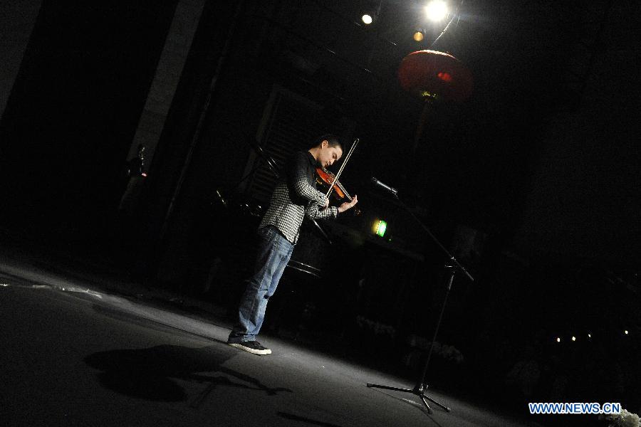 Chinese student Liu Xing plays violin at the Chinese Spring Festival soiree, organized by Chinese students in Brussels, Belgium, Feb. 25, 2015.