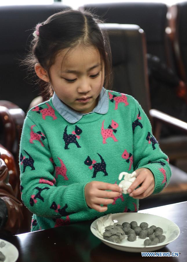 A girl moulds a goat with flour during an activity to celebrate the coming Lantern Festival in Hangzhou, capital of east China's Zhejiang Province, March 4, 2015. The Lantern Festival falls on March 5 this year. (Xinhua/Xu Yu) 