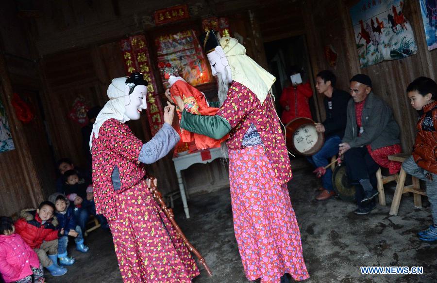 Members of a local Nuo dance team performs Nuo dance to celebrate Chinese lunar New Year in Sanxi Township of Nanfeng County, east China's Jiangxi Province, March 4, 2015. Nuo dance used to be sacrificial rituals staged during festivals in the ancient times to expel evil spirits and pray for good harvests.(Xinhua/Chen Zixia) 