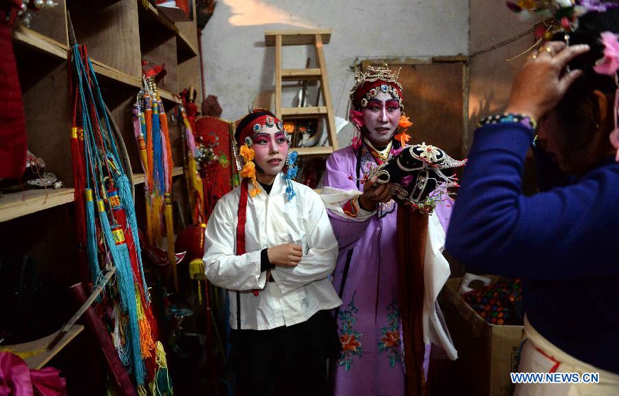 Wei Shuilai (C), a member of the local Meng Opera troupe, prepares for a performance in Shexi Village in Guangchang County, east China's Jiangxi Province, March 2, 2015. The Meng Opera is a local folk opera dated from early Ming Dynasty (1368-1644), and the current Meng Opera troupe was established by villagers in 1980. (Xinhua/Chen Zixia) 