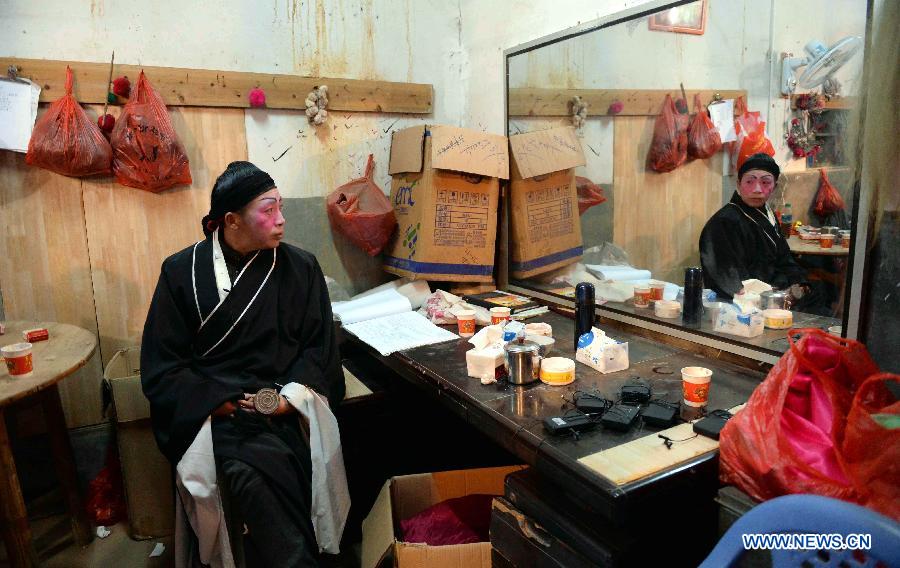 Wei Guilong, a member of the local Meng Opera troupe, prepares for a performance in Shexi Village in Guangchang County, east China's Jiangxi Province, March 2, 2015. The Meng Opera is a local folk opera dated from early Ming Dynasty (1368-1644), and the current Meng Opera troupe was established by villagers in 1980. (Xinhua/Chen Zixia) 