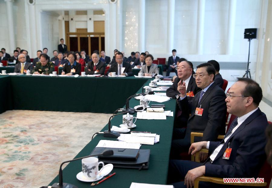 Zhang Dejiang (2nd R), chairman of the Standing Committee of China's National People's Congress (NPC) and a member of the Standing Committee of the Political Bureau of the Communist Party of China (CPC) Central Committee, joins a panel discussion with deputies from southwest China's Chongqing during the third session of the 12th NPC, in Beijing, capital of China, March 9, 2015. 