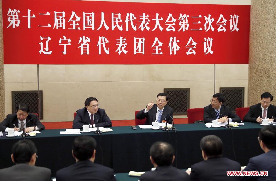 Zhang Dejiang (back, C), chairman of the Standing Committee of China's National People's Congress (NPC) and a member of the Standing Committee of the Political Bureau of the Communist Party of China (CPC) Central Committee, joins a panel discussion with deputies from northeast China's Liaoning Province during the third session of the 12th NPC, in Beijing, capital of China, March 8, 2015. 