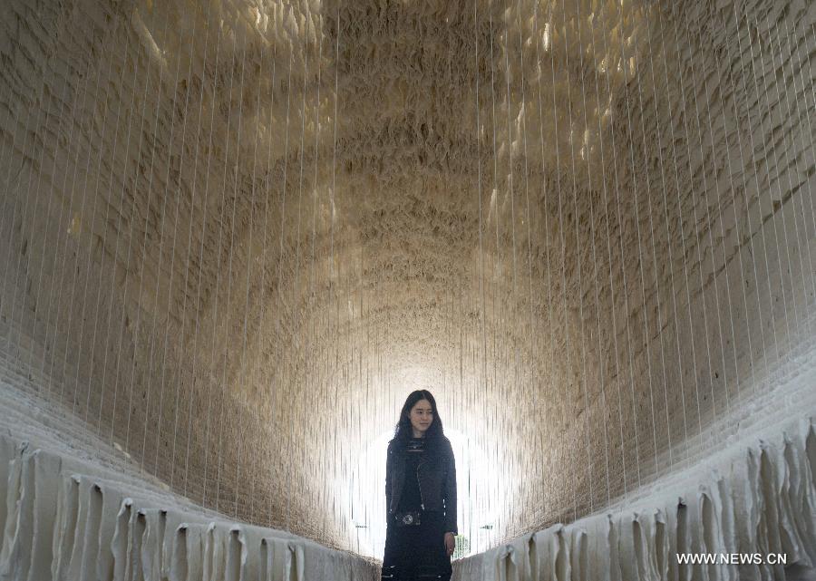 The 18-meter-long artwork is made of bamboo, cotton threads and over 12,000 pieces of Chinese art paper.
