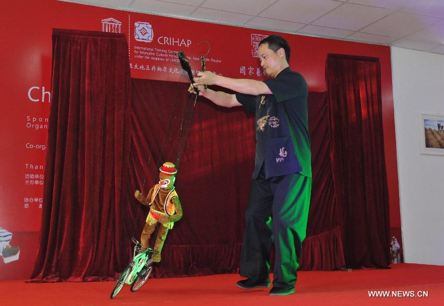 An eight-member troupe of China's Fujian puppetry practitioners performed traditional puppetry here on Wednesday to promote cultural ties between the two countries.