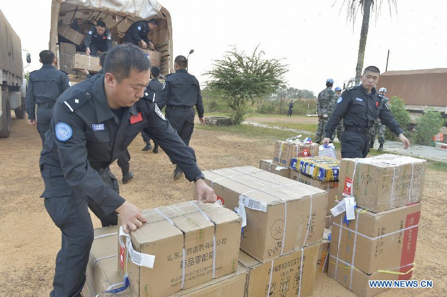 Police officers of the third Chinese riot police squad to join a UN peacekeeping mission in Liberia transport goods after their arrival in Monrovia, Liberia on March 11, 2015. 