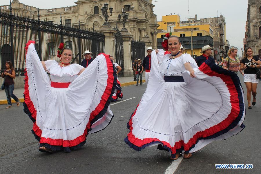 Costa Rican dancers perform during the 'Parade of the World Cultures' in the framework of the 8th International Meeting of Folklore 'My Peru 2015', in Lima city, capital of Peru, on March 14, 2015.