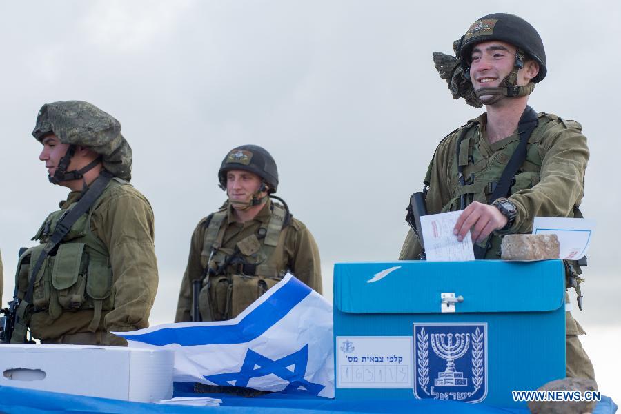 An Israeli soldier casts his ballot two days early at an army base on the Golan Heights, close to the border with Syria, on March 15, 2015.