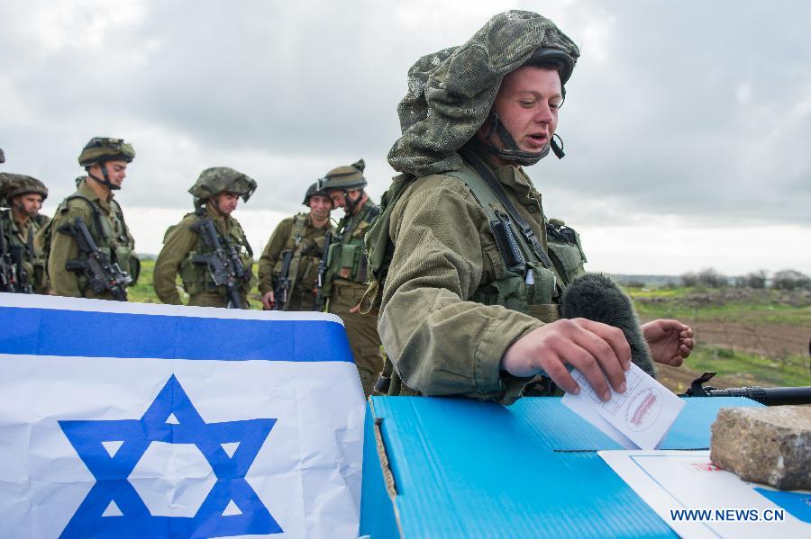 An Israeli soldier casts his ballot two days early at an army base on the Golan Heights, close to the border with Syria, on March 15, 2015.