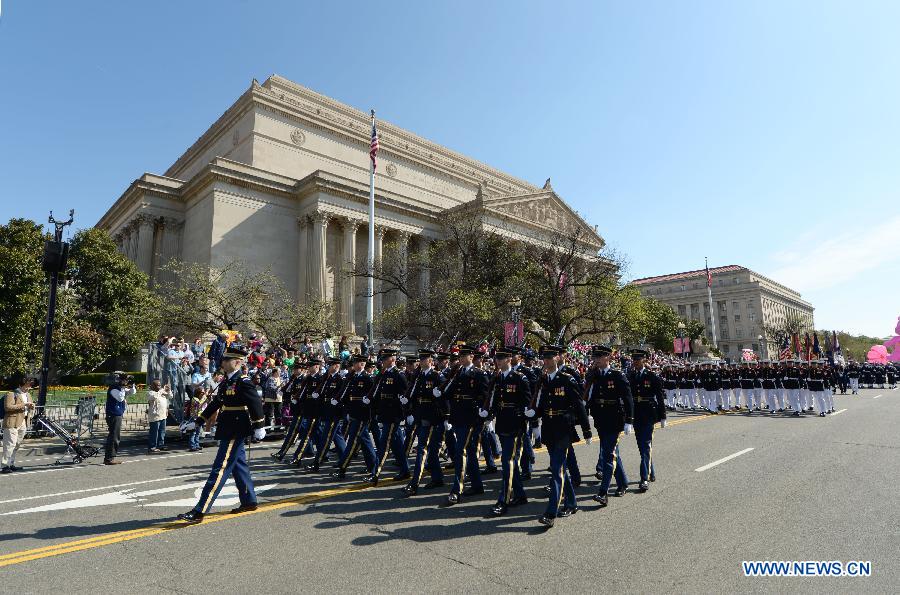 Honour guards attend the annual Cherry Blossom Festival Parade along the Constitution Avenue in Washington D.C., capital of the United States, April 11, 2015. 