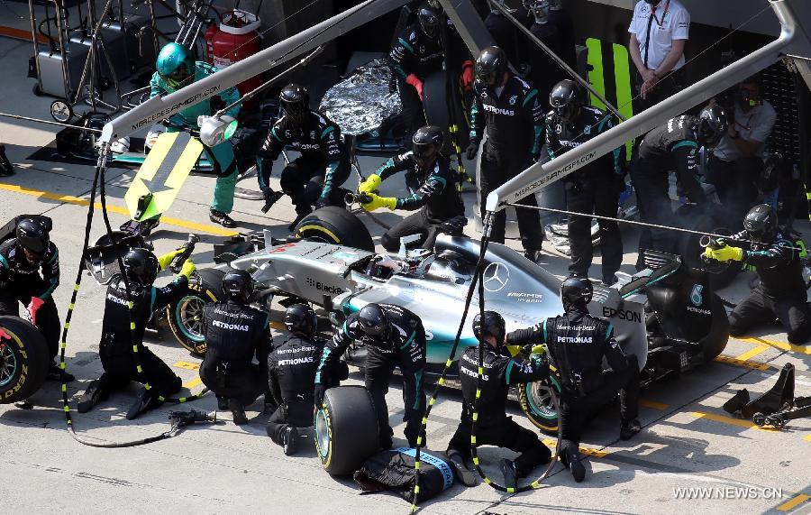 Mercedes AMG driver Lewis Hamilton of Britain takes his car in for a pit-stop during the Chinese Formula One Grand Prix at Shanghai International Circuit in Shanghai, China, April 12, 2015.