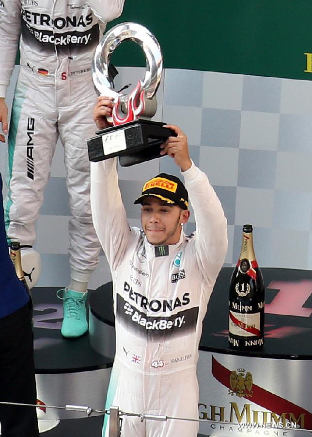 Mercedes AMG driver Lewis Hamilton of Britain poses with his trophy after winning the Chinese Formula One Grand Prix at Shanghai International Circuit in Shanghai, China, April 12, 2015.