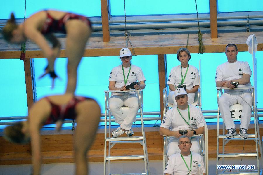 Judges watch the women's 10m synchro platform final match at FINA Diving World Series in Kazan, Russia, April 24, 2015.