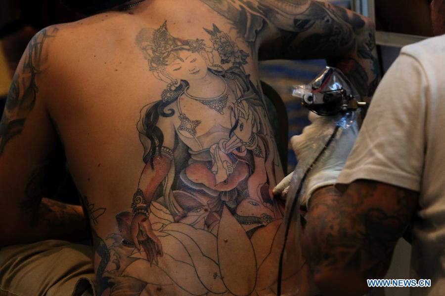 A man makes a tattoo during the 5th International Nepal Tattoo Convention in Kathmandu, Nepal, April 24, 2015.