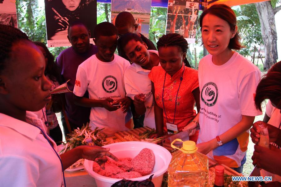 Chinese staff and local students makes jiaozi, or dumplings, during the first Confucius Institute Open Day at Makerere University in Kampala, Uganda, April 25, 2015. 