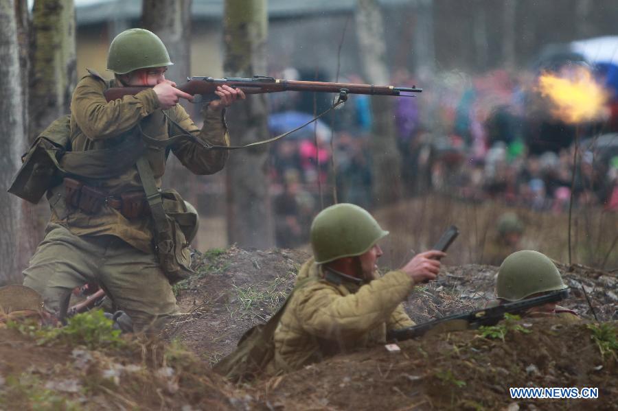 Members from a military club reproduce parts of the Berlin battle in 1945 to mark the 70th anniversary of the victory of the World War II in St. Petersburg, Russia, April 26, 2015.