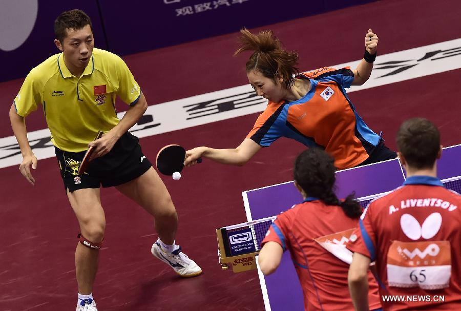 China's Xu Xin(Rear, L)/South Korea's Yang Haeun(Rear, R) compete during the Mixed Doubles match against Russia's Alexey Liventsov/Yulia Prokhorova at the 53rd Table Tennis World Championships in Suzhou, city of east China's Jiangsu Province, on April 29, 2015. Xu Xin/Yang Haeun won the match 4-2. (Xinhua/Han Yuqing) 