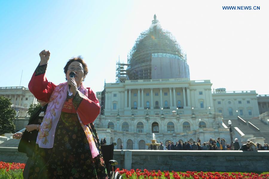Nearly 200 people held signs and shouted slogans in a protest against Abe's handling of history issues, demanding the Japanese leader to unequivocally apologize for his country's wartime crimes here on Tuesday.