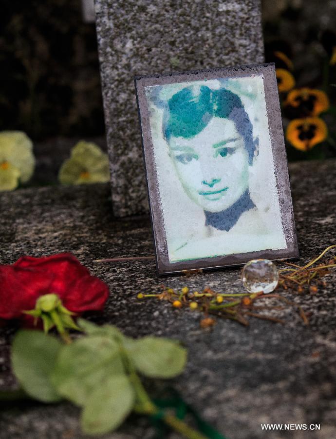 A rose is placed at the grave of actress Audrey Hepburn in Tolochenaz village in Switzerland, May 4, 2015.