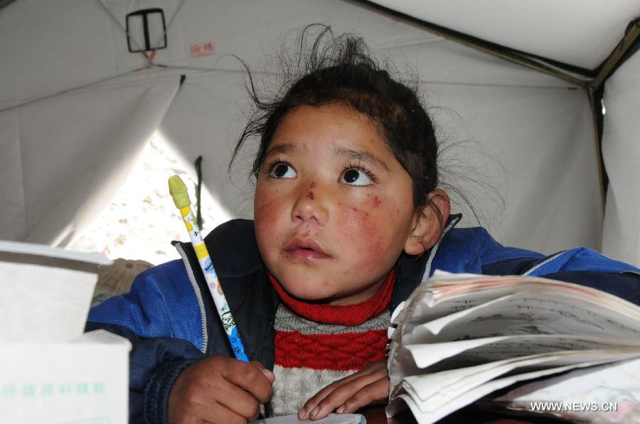 A pupil attends class in a tent school in Rongxar Township of Tingri County, southwest China's Tibet Autonomous Region, May 4, 2015