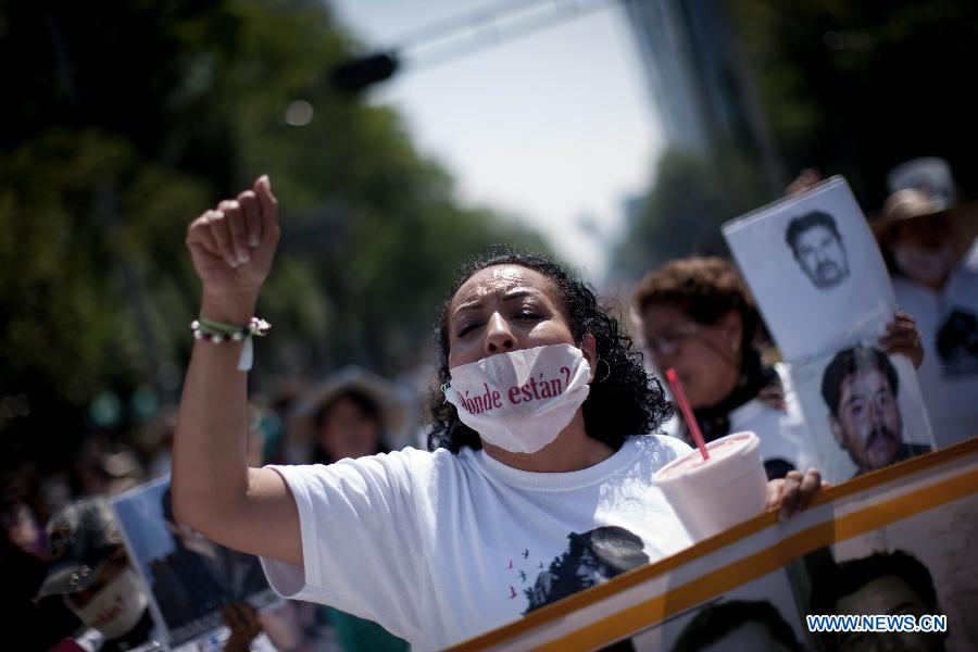 A woman shouts slogan during a protest in Mexico City, capital of Mexico, on May 10, 2015.