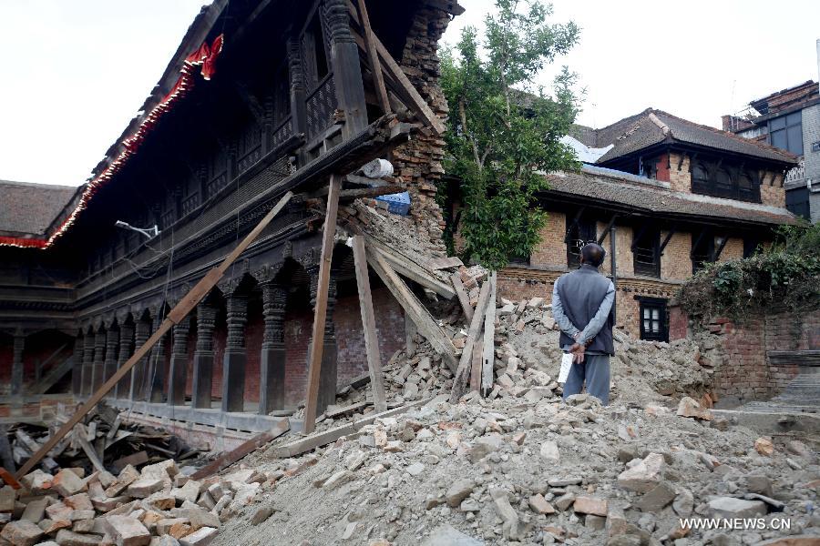 A man looks at the damaged 55 windows palace at Bhaktapur Durbar Square in Nepal, May 13, 2015. A fresh 7.5-magnitude earthquake claimed at least 65 lives and injured over 1,900 people in Nepal on Tuesday. (Xinhua/Pratap Thapa)  
