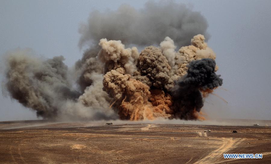 Smokes rise following a strike by a US strategic bomber as military forces take part in joint Jordan-US maneuvers during the 'Eager Lion' military exercises in Mudawwara, near the border with Saudi Arabia, some 280 kilometres south of the Jordanian capital, Amman, on May 18, 2015.
