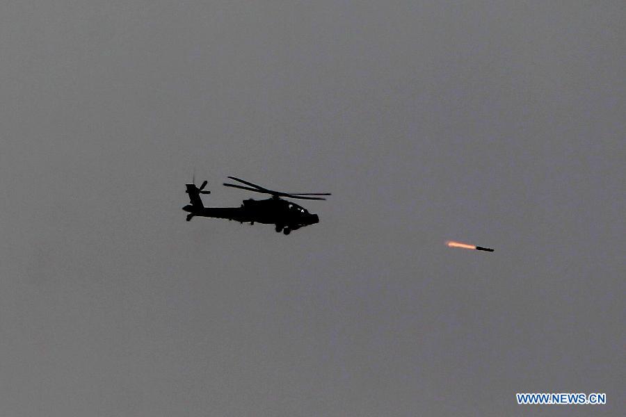 A helicopter fires as taking part in joint Jordan-US maneuvers during the 'Eager Lion' military exercises in Mudawwara, near the border with Saudi Arabia, some 280 kilometres south of the Jordanian capital, Amman, on May 18, 2015.