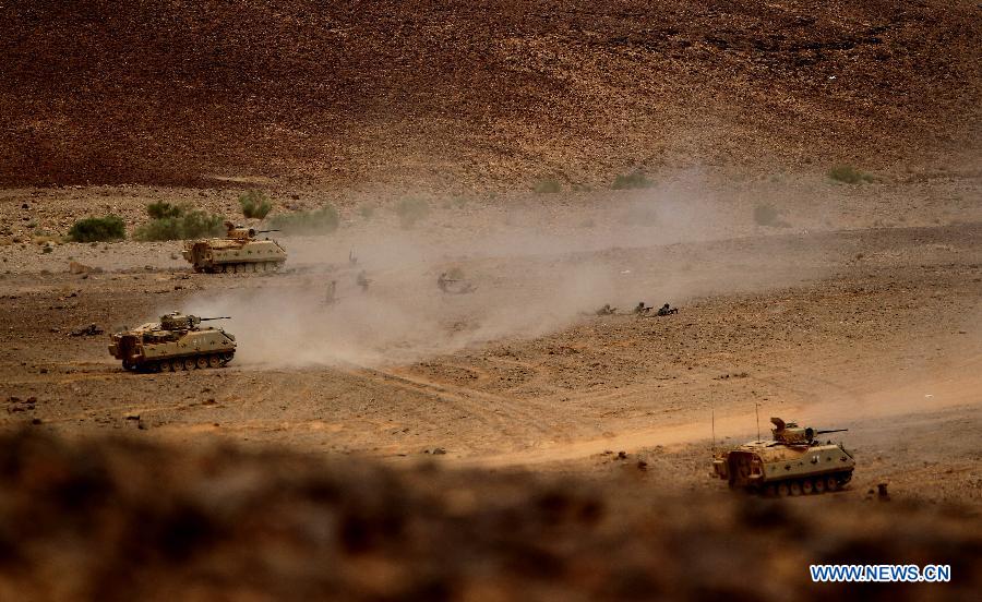 Tanks advance as they take part in joint Jordan-US maneuvers during the 'Eager Lion' military exercises in Mudawwara, near the border with Saudi Arabia, some 280 kilometres south of the Jordanian capital, Amman, on May 18, 2015.