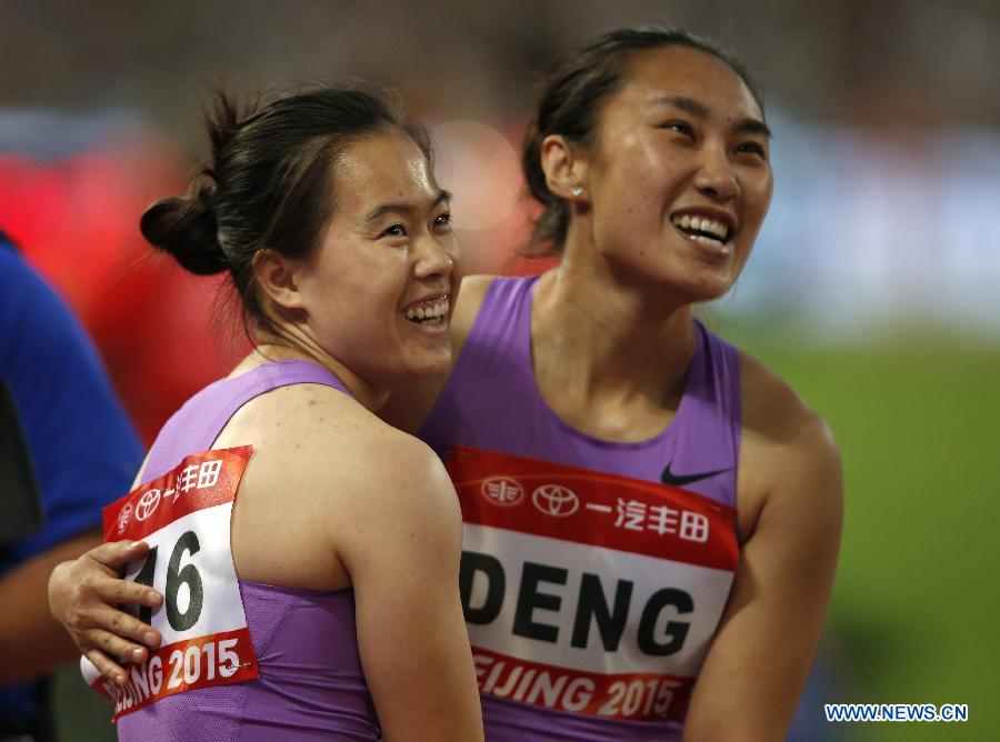 Wu Shuijiao (L) of China celebrates with her teammate Deng Ru after Women's 100m Hurdles Final of 2015 IAAF World Challenge at National Stadium (Birds Nest) in Beijing, China on May 20, 2015. 