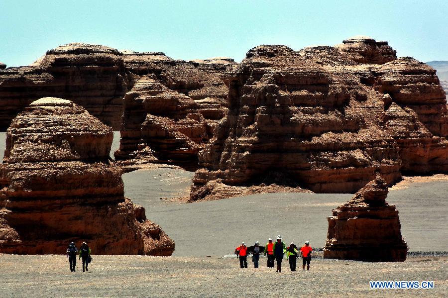 Tourists visit the Dunhuang Yardang National Geopark in Dunhuang, northwest China's Gansu Province, May 24, 2015. (Xinhua/Wang Song)