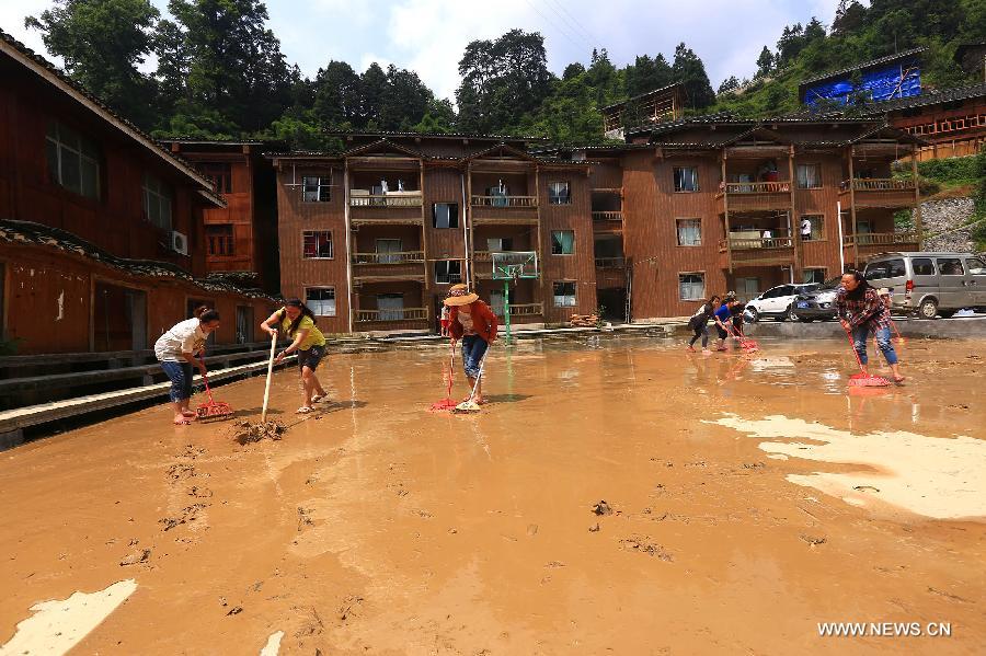 Villagers clean yards after rainstorms in Leishan County, southwest China's Guizhou Province, May 28, 2015. Leishan County lost access to power and water supplies after torrential rain battered the area from Tuesday night to Wednesday. The rescue work is underway.