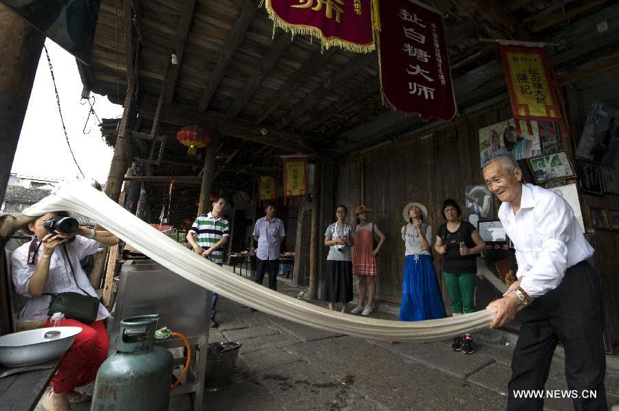 Chen Jinshui, who is more than 80 years old and learned the sugar-pulling technique from 13 years old, is always a highlight as he showcases his sugar-pulling technique, an intangible culture heritage, in Anchang. 