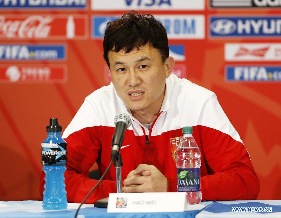 China's head coach Hao Wei attends a press conference at the Commonwealth Stadium in Edmonton, Canada, June 5, 2015. 