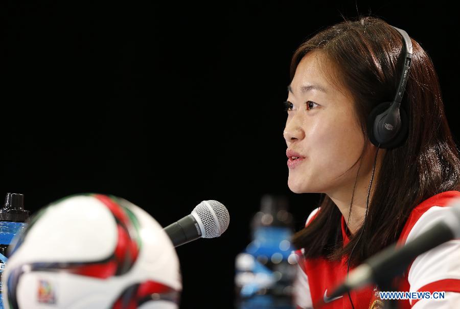 China's captain Wu Haiyan attends a press conference at the Commonwealth Stadium in Edmonton, Canada, June 5, 2015. 