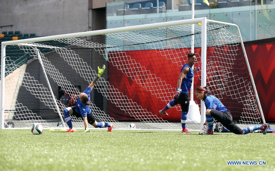 Canada's goalkeeper Stephanie Labbe (R) and Erin McLeod (L) and Karina LeBlanc attend a training session in the Commonwealth Stadium one day ahead of the opening match with China at the 2015 FIFA Women's World Cup in Edmonton, Canada, June 5, 2015.