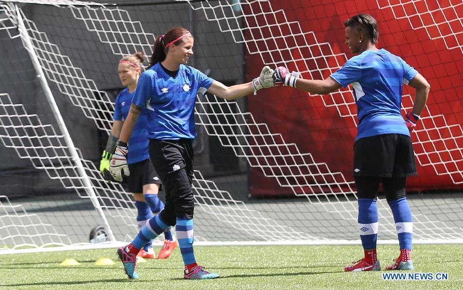 Canada's goalkeeper Stephanie Labbe (C) and Karina LeBlanc react during a training session in the Commonwealth Stadium one day ahead of the opening match with China at the 2015 FIFA Women's World Cup in Edmonton, Canada, June 5, 2015. 