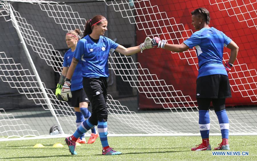 Canada's goalkeeper Stephanie Labbe (C) and Karina LeBlanc react during a training session in the Commonwealth Stadium one day ahead of the opening match with China at the 2015 FIFA Women's World Cup in Edmonton, Canada, June 5, 2015. 