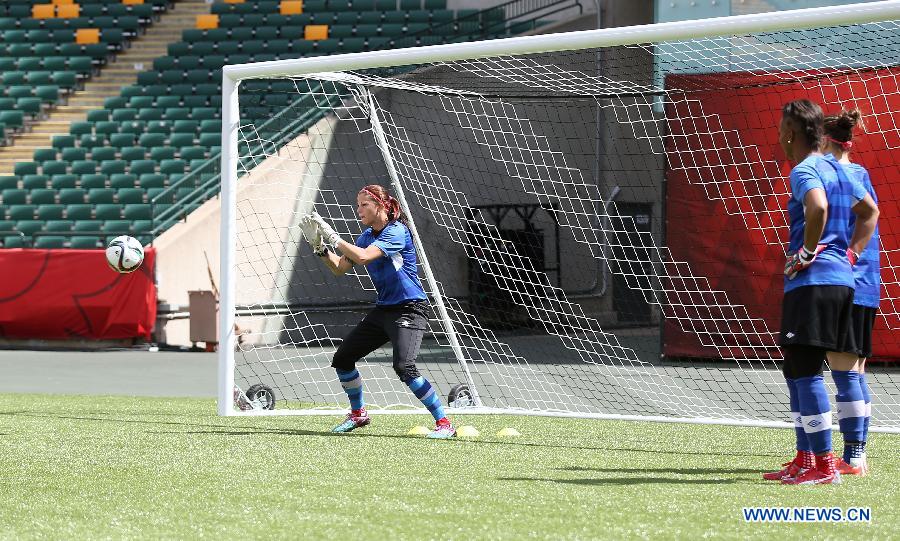 Canada's goalkeeper Stephanie Labbe (L) trains as Erin McLeod (R) and Karina LeBlanc watch during the training session in the Commonwealth Stadium one day ahead of the opening match with China at the 2015 FIFA Women's World Cup in Edmonton, Canada, June 5, 2015. 