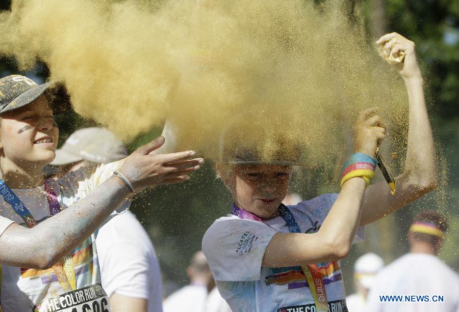 Runners spray colour powder to each other during the colour run held in Vancouver, Canada, June 13, 2015. 