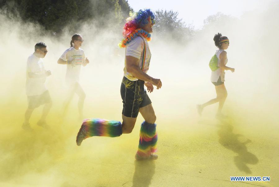 Runners pass through the colour smoke during the colour run held in Vancouver, Canada, June 13, 2015. 