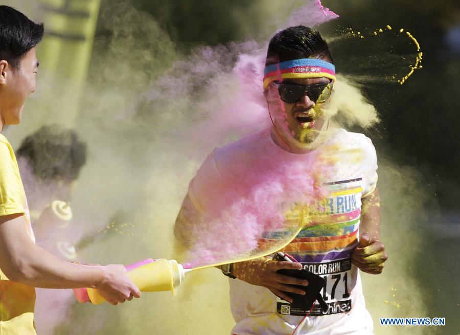 Runners are sprayed with colour powder during the colour run held in Vancouver, Canada, June 13, 2015. 