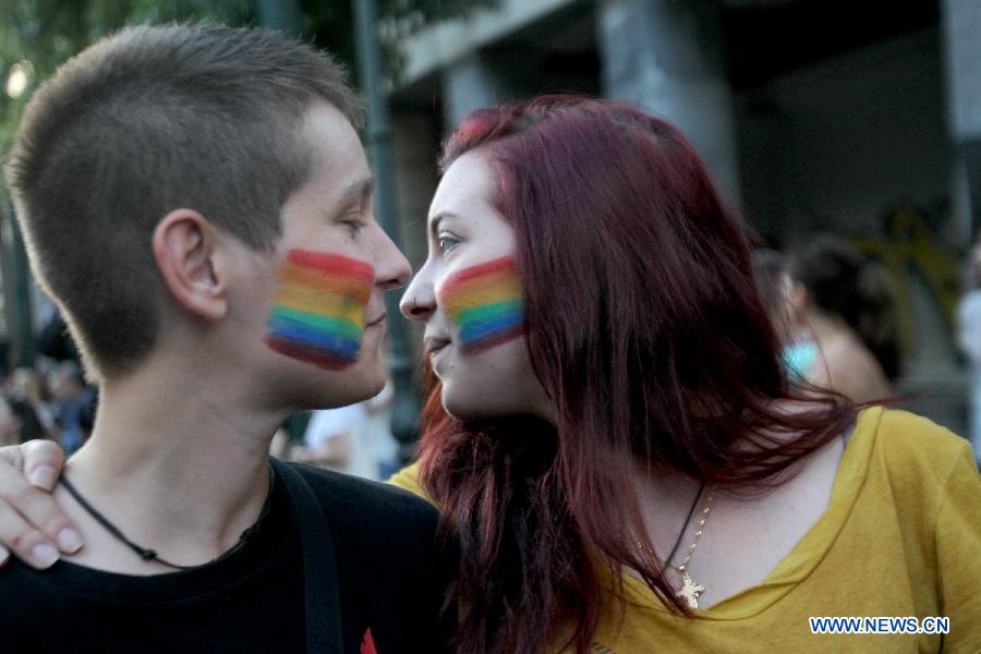 Protesters whose faces are painted with rainbow colors participate during an annual Gay Pride rally in Athens, Greece, June 13, 2015. 